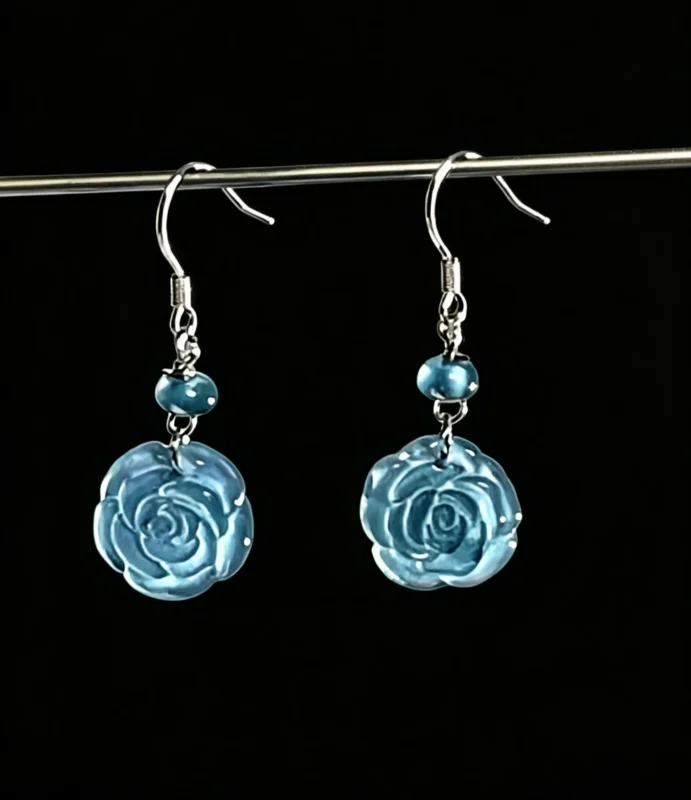 Hand carved ice blue jade rose silver hook drop earrings, bespoke custom jewelry, remake available with your preferred natural gemstone, black background studio shot